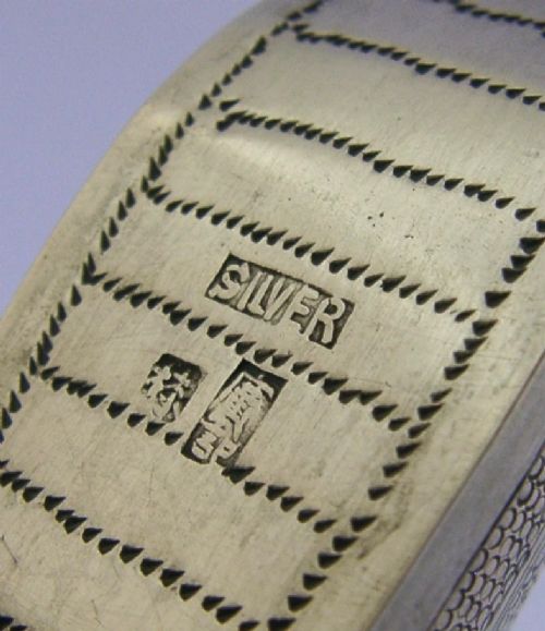 An antique Chinese export silver novelty pin cushion formed in the shape of a traditional slipper, featuring chased bat motifs and textured surface decoration. View IX