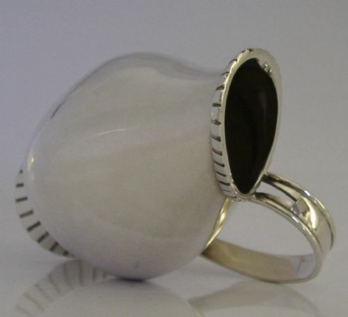A pear-shaped mid-century sterling silver cream jug featuring a fluted rim, a matching fluted foot ring, and a single loop handle. View VII