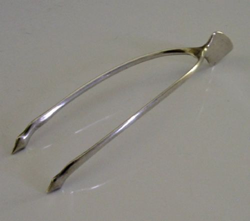 A pair of solid sterling silver sugar tongs shaped like a bird wishbone with visible British hallmarks on the upper bridge. View III