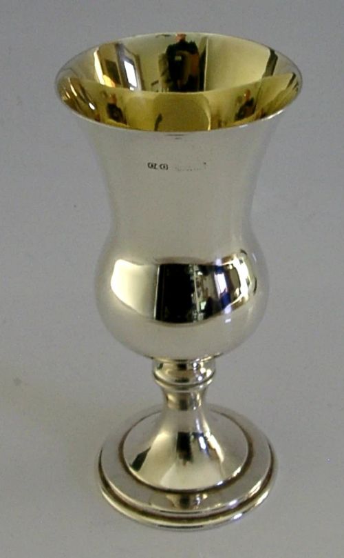 A polished mid-century sterling silver wine goblet featuring a flared rim, gilt interior wash, visible hallmarks, and a circular stepped base. View II