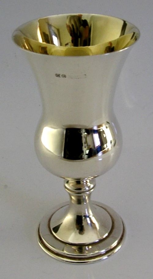 A polished mid-century sterling silver wine goblet featuring a flared rim, gilt interior wash, visible hallmarks, and a circular stepped base. View IV