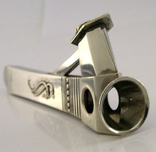 A mid-century sterling silver cigar cutter featuring a textured casing with a raised scroll motif and a stainless steel cutting blade. View III