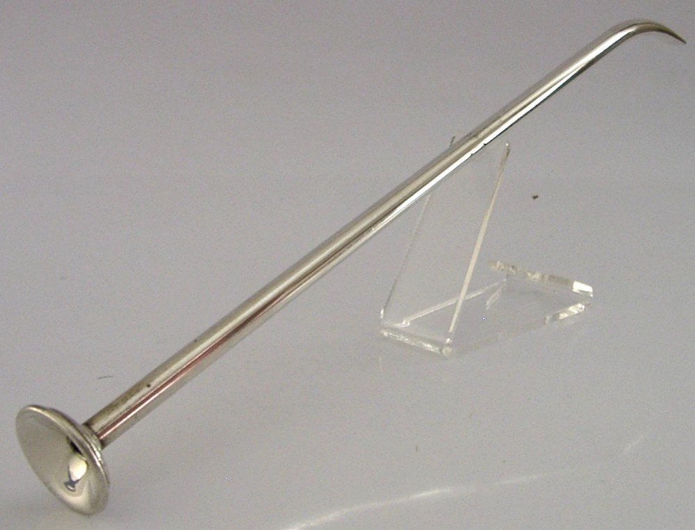 A long, slender Victorian sterling silver blowpipe candle snuffer featuring a flared mouthpiece and a curved nozzle tip.