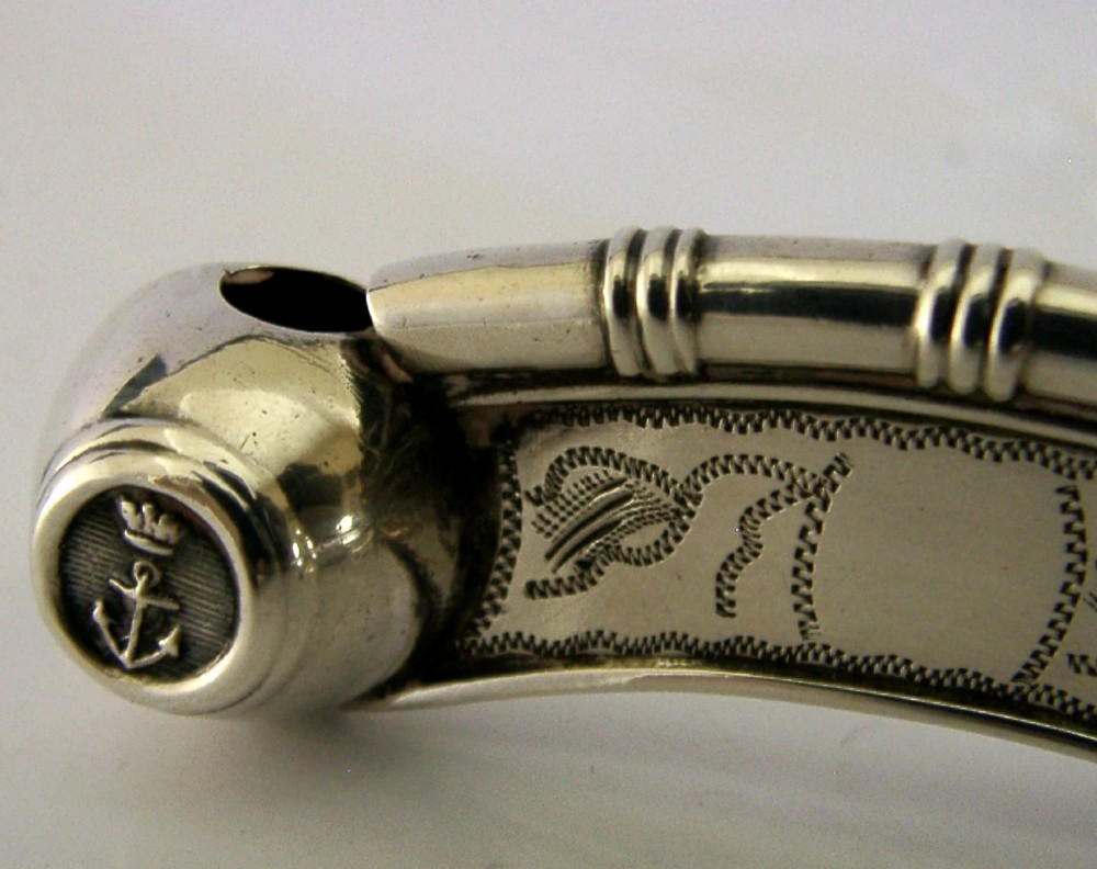 A Victorian sterling silver boatswains whistle featuring bright-cut engraving, British silver hallmarks, and a crowned anchor emblem on the spherical buoy. View IV