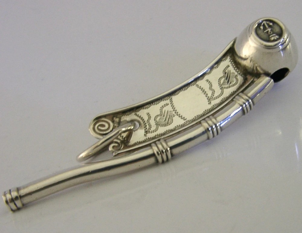 A Victorian sterling silver boatswains whistle featuring bright-cut engraving, British silver hallmarks, and a crowned anchor emblem on the spherical buoy. View VI