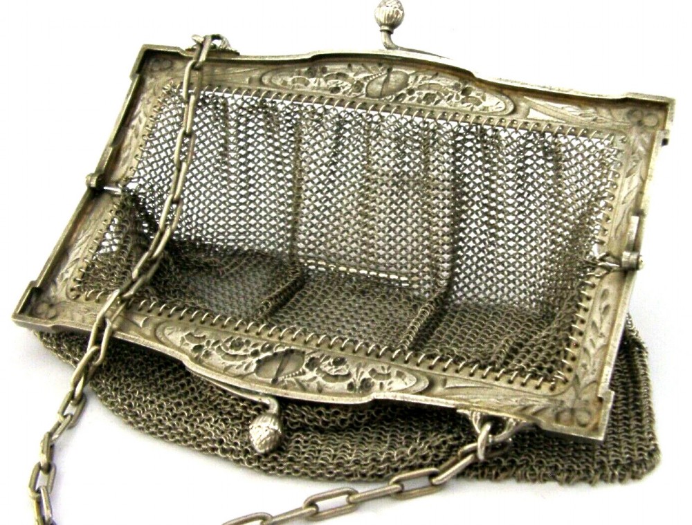 An antique French solid silver chain link mesh purse featuring an ornate Art Nouveau carved frame with a pinecone clasp. View II