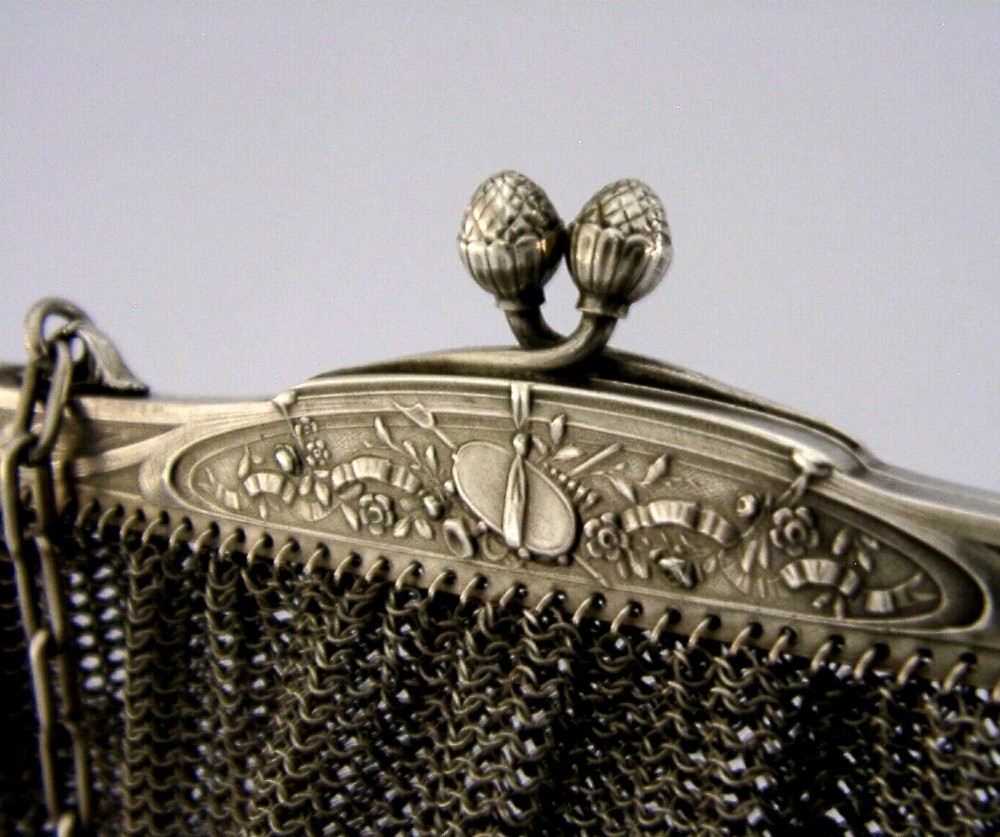 An antique French solid silver chain link mesh purse featuring an ornate Art Nouveau carved frame with a pinecone clasp. View III