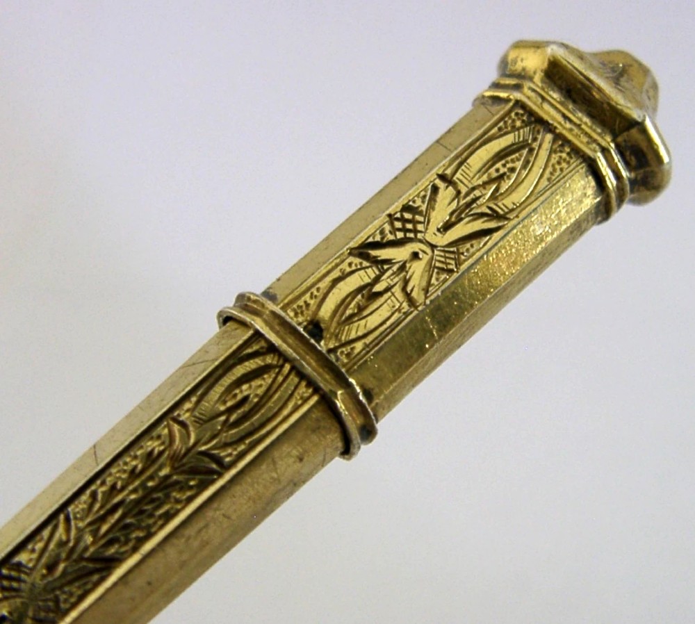 An antique French silver gilt needle case featuring engraved foliage and moulded finials. View II