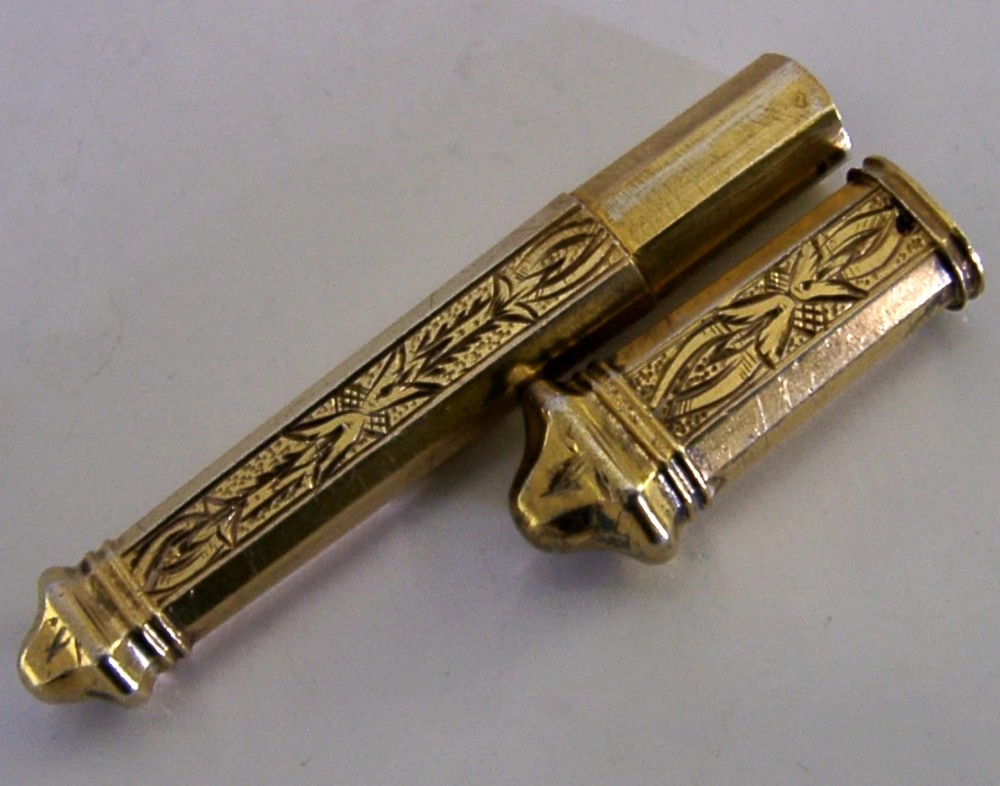 An antique French silver gilt needle case featuring engraved foliage and moulded finials. View VI