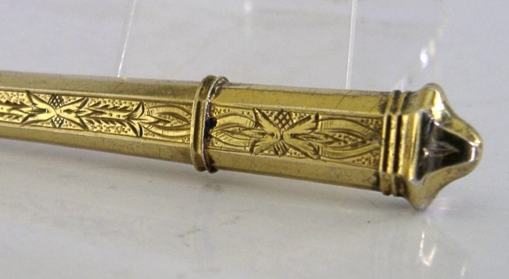 An antique French silver gilt needle case featuring engraved foliage and moulded finials. View VII