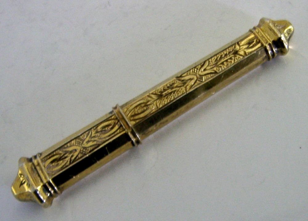 An antique French silver gilt needle case featuring engraved foliage and moulded finials. View VIII