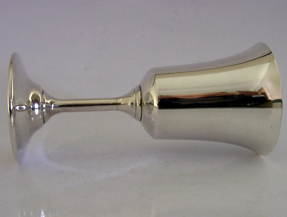 A polished sterling silver goblet featuring a flared bowl, slender stem, and circular stepped base. View V