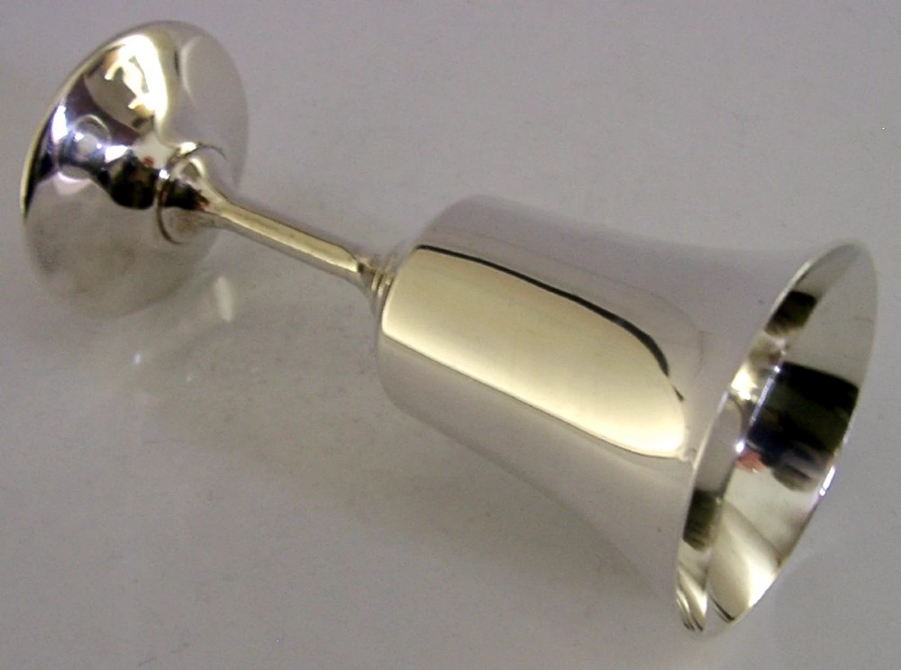 A polished sterling silver goblet featuring a flared bowl, slender stem, and circular stepped base. View VI