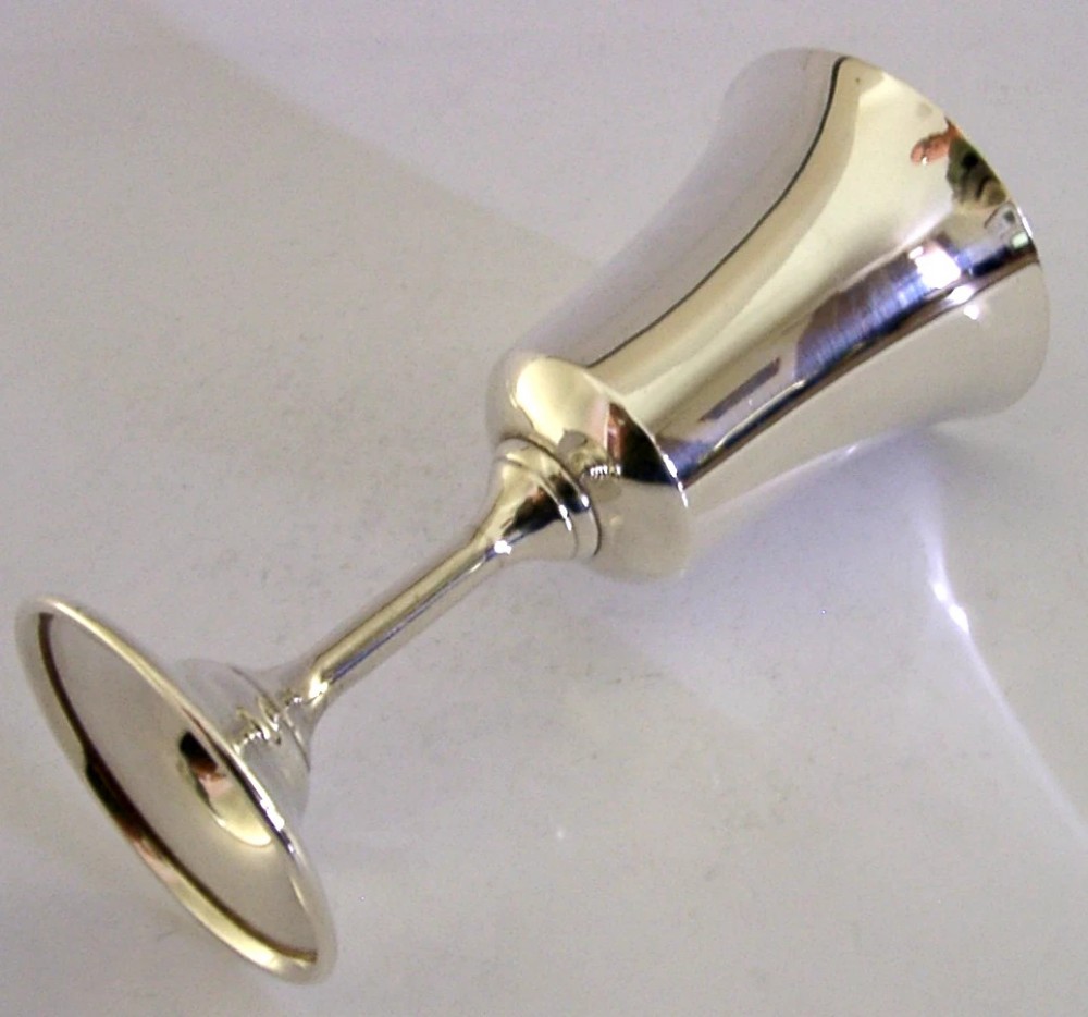 A polished sterling silver goblet featuring a flared bowl, slender stem, and circular stepped base. View VII