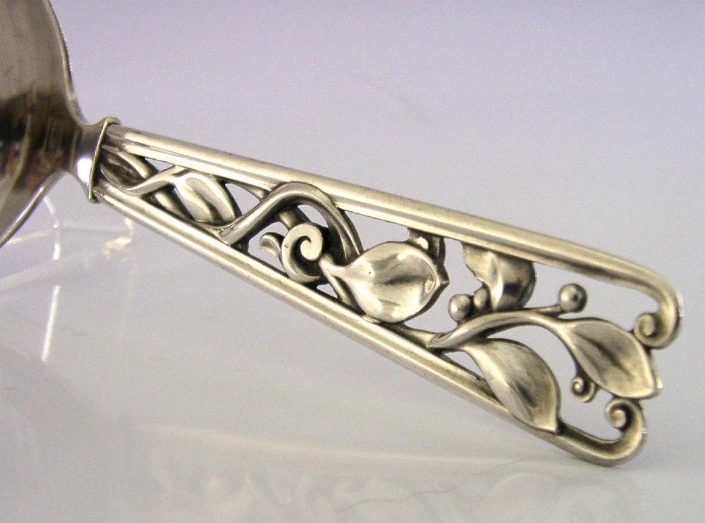 A Danish solid silver sauce ladle featuring a double-lipped deep bowl and an intricate openwork carved leaf handle. View II