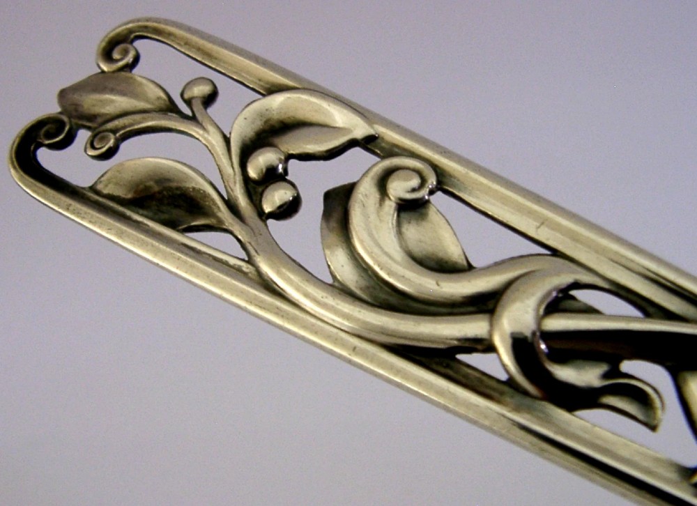 A Danish solid silver sauce ladle featuring a double-lipped deep bowl and an intricate openwork carved leaf handle. View VII