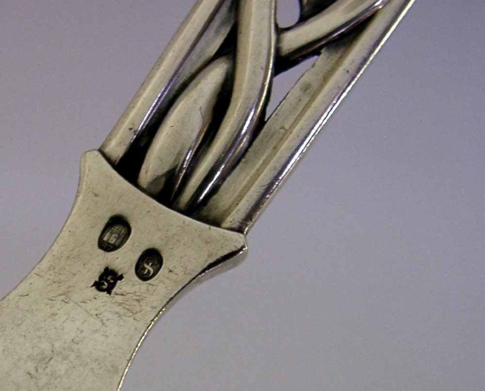 A Danish solid silver sauce ladle featuring a double-lipped deep bowl and an intricate openwork carved leaf handle. View VIII