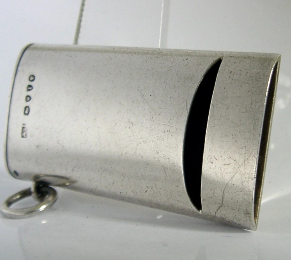 A rectangular Victorian sterling silver combined vesta case and whistle featuring hallmarked silver casing and an attached suspension ring.