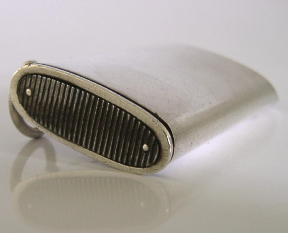 A rectangular Victorian sterling silver combined vesta case and whistle featuring hallmarked silver casing and an attached suspension ring. View IV