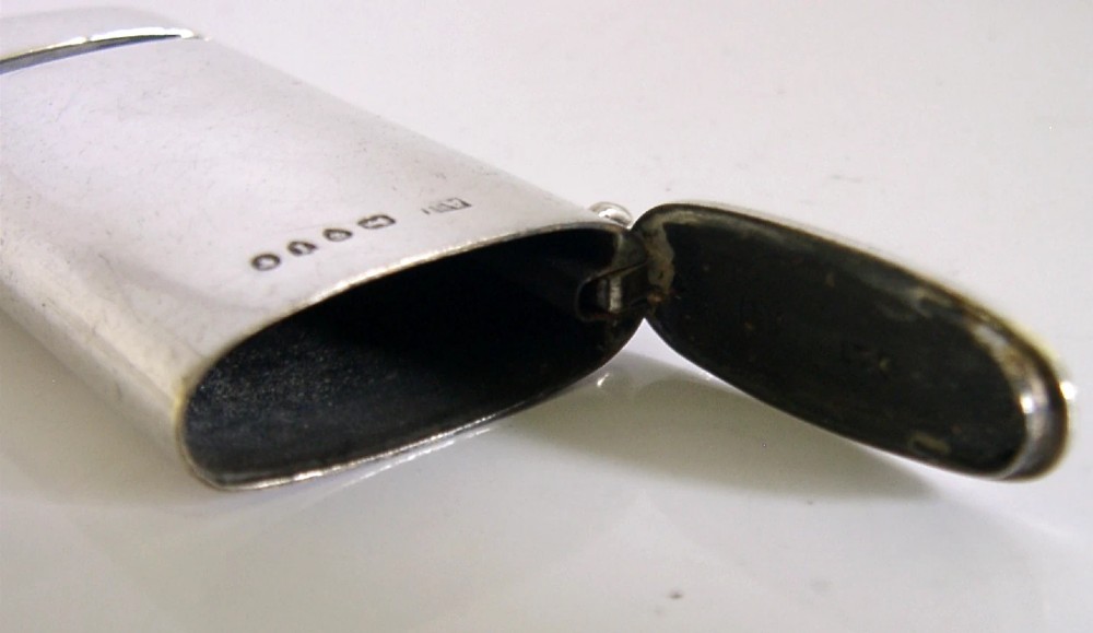 A rectangular Victorian sterling silver combined vesta case and whistle featuring hallmarked silver casing and an attached suspension ring. View VIII