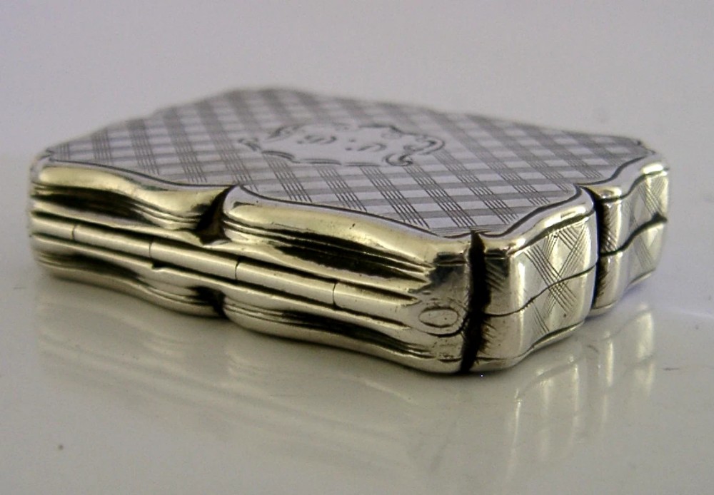 An open Victorian sterling silver vinaigrette box by Nathaniel Mills featuring a scalloped edge, cross-hatch engraving, and an internal hinged pierced gilt grill. View VI
