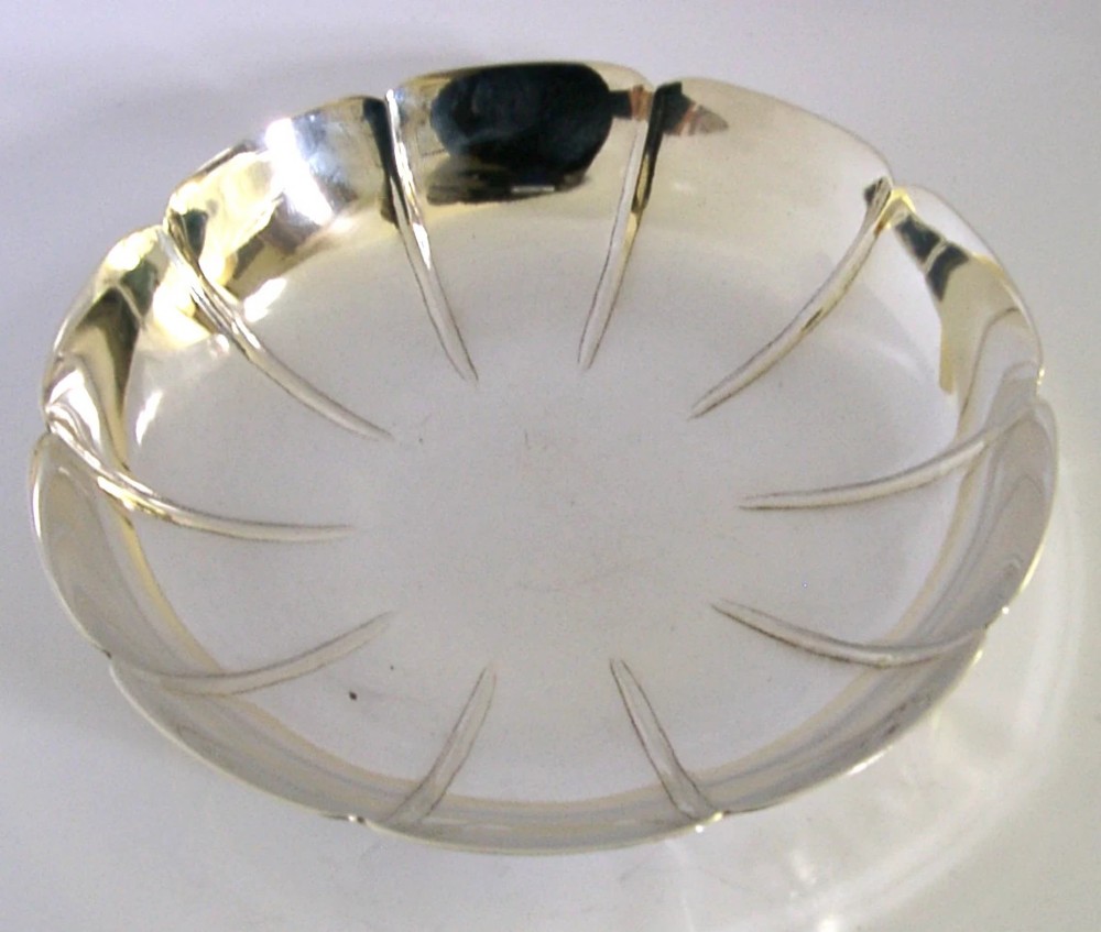 A circular mid-century sterling silver dish featuring a lobed rim and radiating linear relief pattern. View II