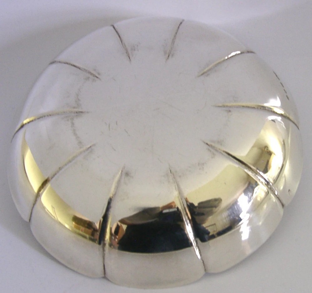 A circular mid-century sterling silver dish featuring a lobed rim and radiating linear relief pattern. View III