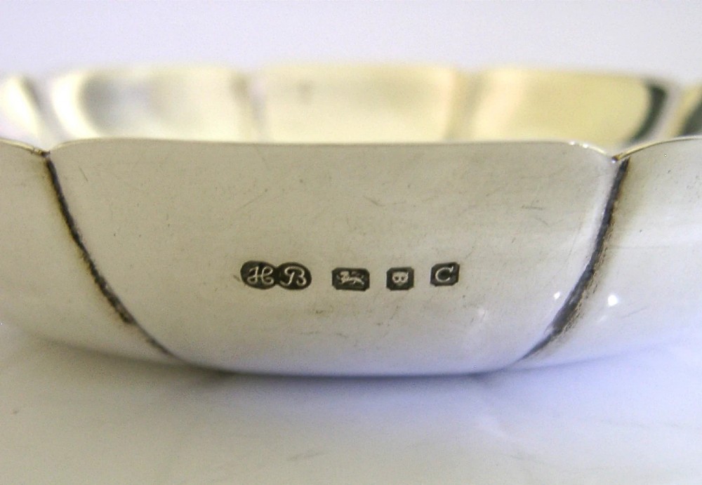 A circular mid-century sterling silver dish featuring a lobed rim and radiating linear relief pattern. View IV
