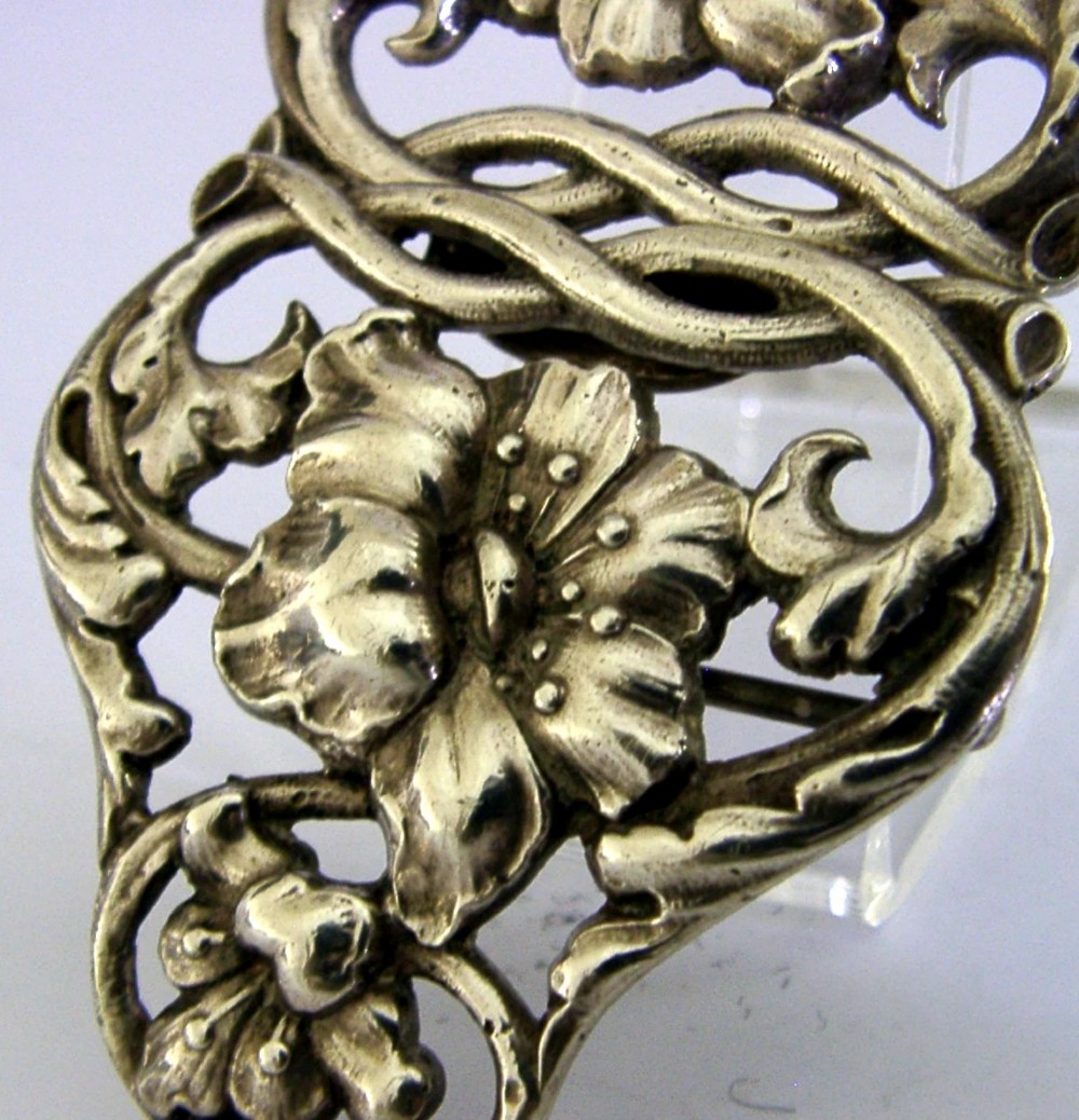 A two-piece cast sterling silver Art Nouveau belt buckle featuring relief floral and foliage motifs. View II