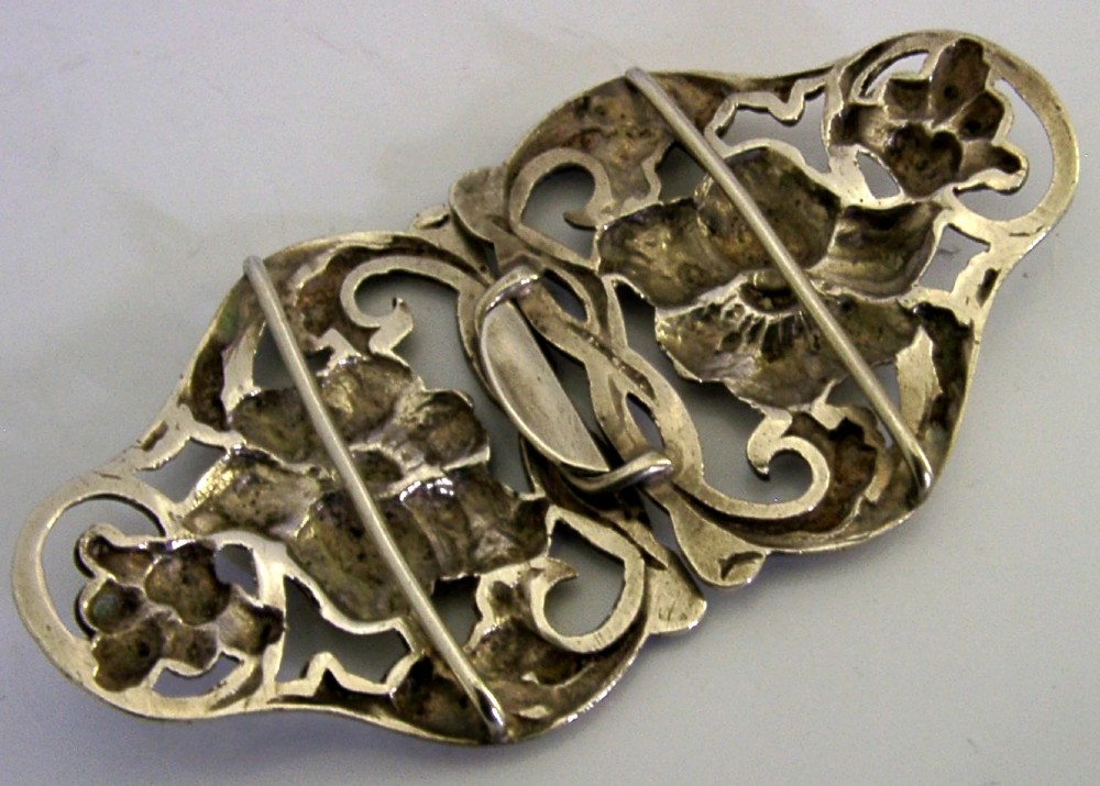 A two-piece cast sterling silver Art Nouveau belt buckle featuring relief floral and foliage motifs. View VII