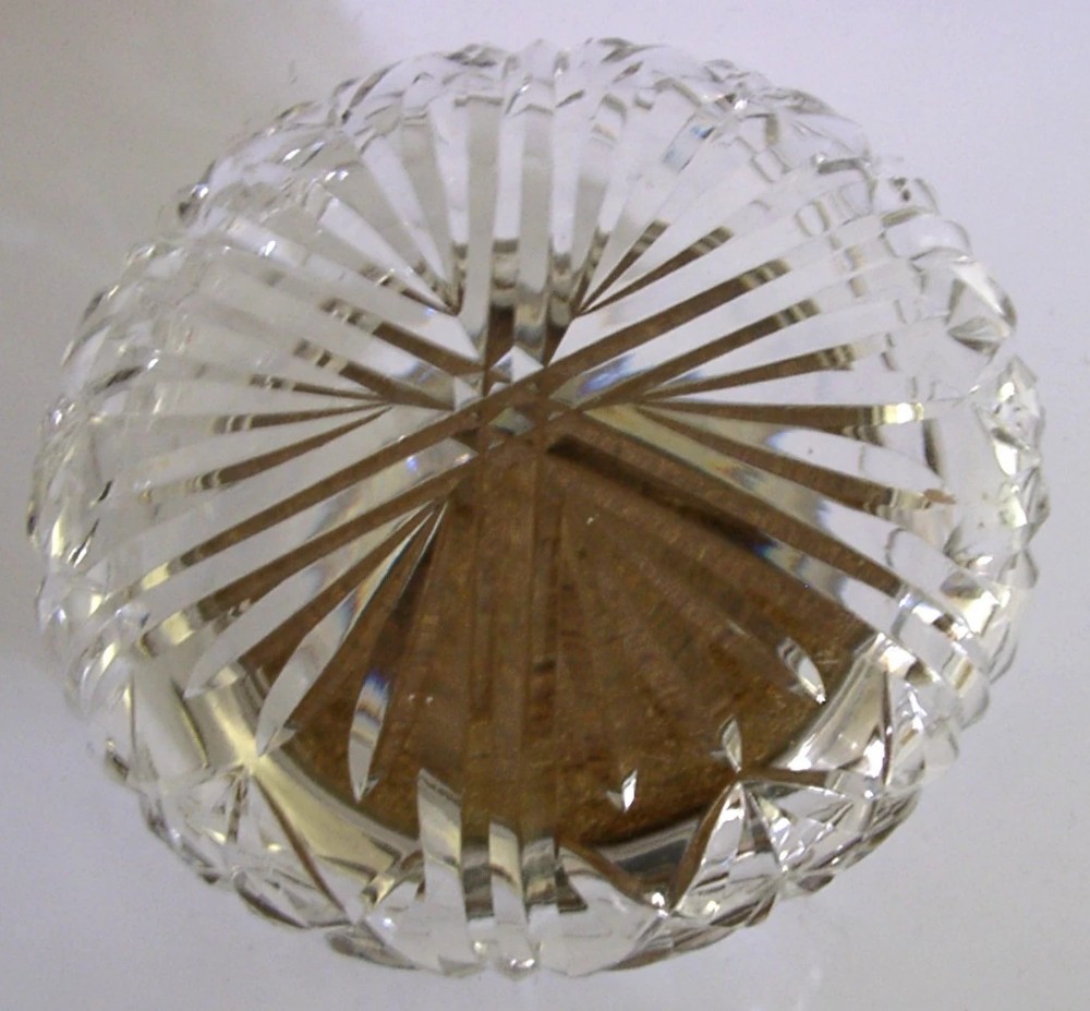 A circular cut glass dressing table jar topped with a white guilloche enamel and sterling silver lid. View VIII