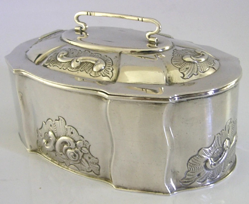 An oval Danish sterling silver jewellery box with an open hinged lid, featuring lobed sides and embossed scroll motifs. View III