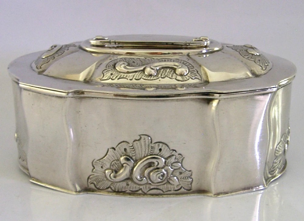 An oval Danish sterling silver jewellery box with an open hinged lid, featuring lobed sides and embossed scroll motifs. View V