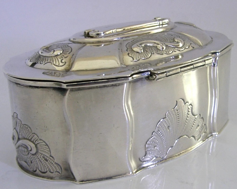 An oval Danish sterling silver jewellery box with an open hinged lid, featuring lobed sides and embossed scroll motifs. View VI