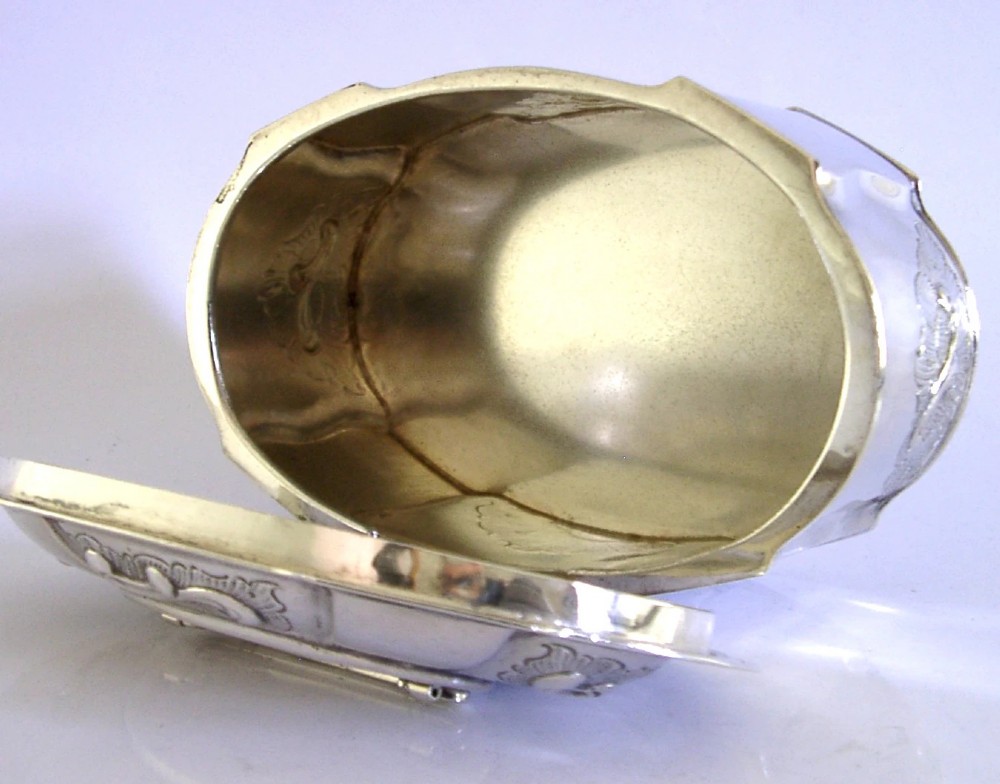 An oval Danish sterling silver jewellery box with an open hinged lid, featuring lobed sides and embossed scroll motifs. View IX