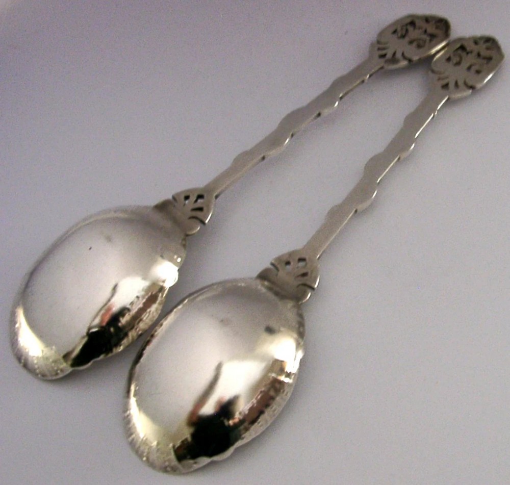 A pair of Victorian silver-plated serving spoons featuring handles entwined with relief-moulded snakes and engraved oval bowls with gilded borders. View VI