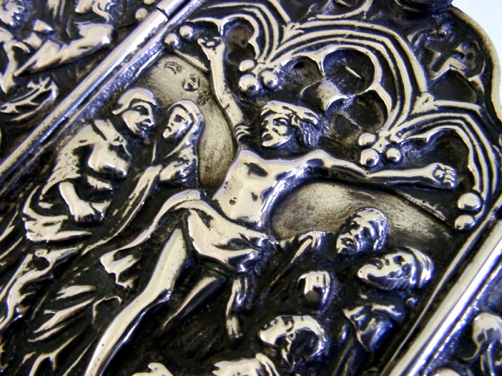 A late nineteenth-century German Hanau silver folding travel triptych featuring a central relief depiction of the Crucifixion flanked by hinged side panels within Gothic arches. View III