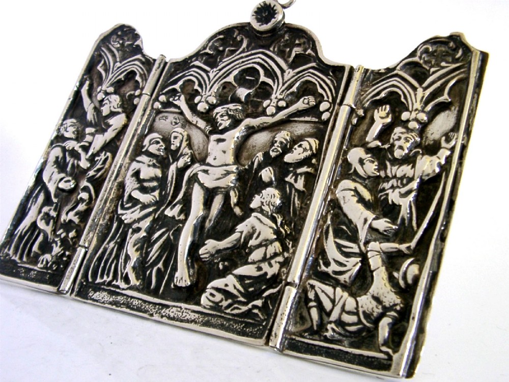 A late nineteenth-century German Hanau silver folding travel triptych featuring a central relief depiction of the Crucifixion flanked by hinged side panels within Gothic arches. View IV