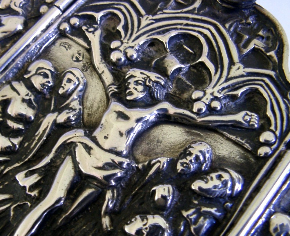 A late nineteenth-century German Hanau silver folding travel triptych featuring a central relief depiction of the Crucifixion flanked by hinged side panels within Gothic arches. View V