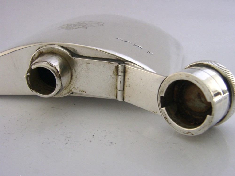 A curved sterling silver hip flask featuring an engraved East Surrey Regiment crest and clear British silver hallmarks. View IV