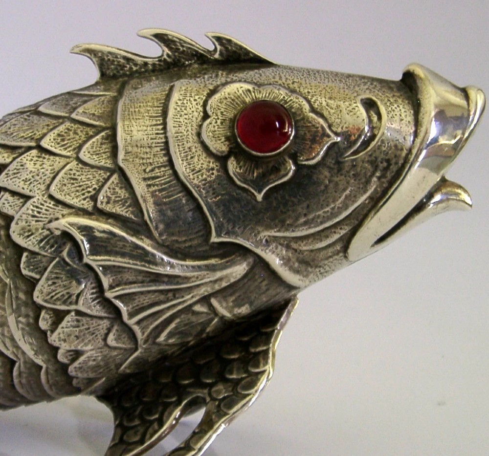 A mid-twentieth-century Spanish 915 silver articulated fish figure with engraved scales, structured fins, and a red cabochon eye. View II