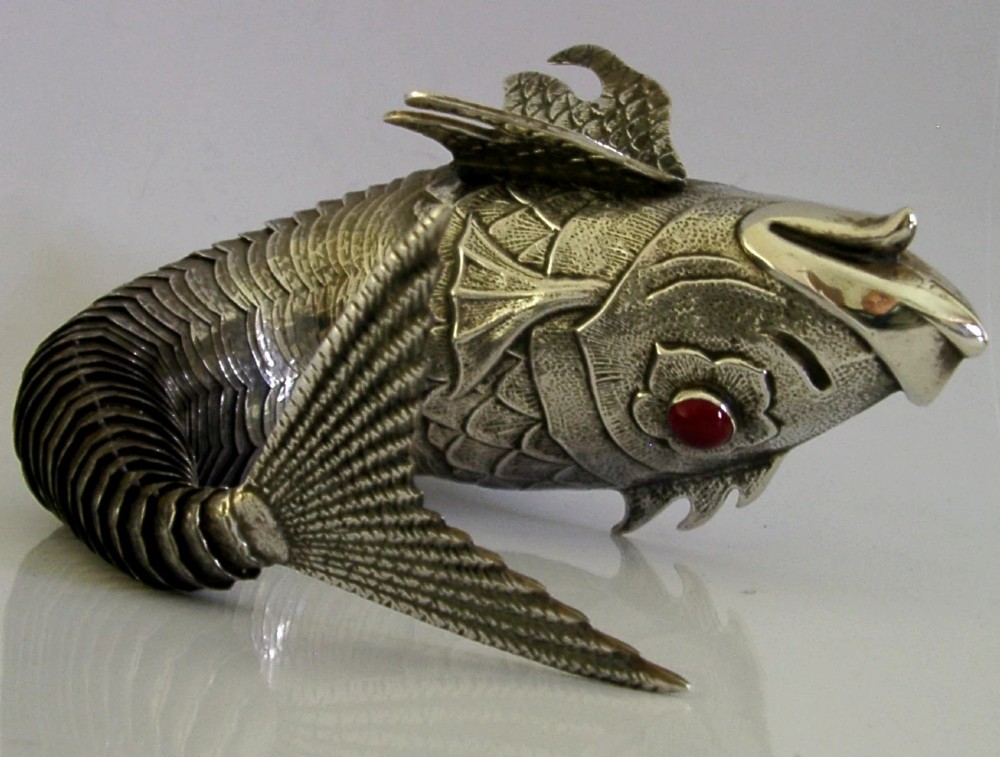 A mid-twentieth-century Spanish 915 silver articulated fish figure with engraved scales, structured fins, and a red cabochon eye. View VIII