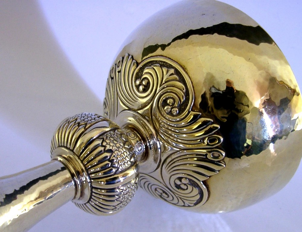 A gold-coloured sterling silver-gilt chalice with a hand-hammered bowl, a decorative knop stem, and a Celtic cross emblem on the flared base. View II