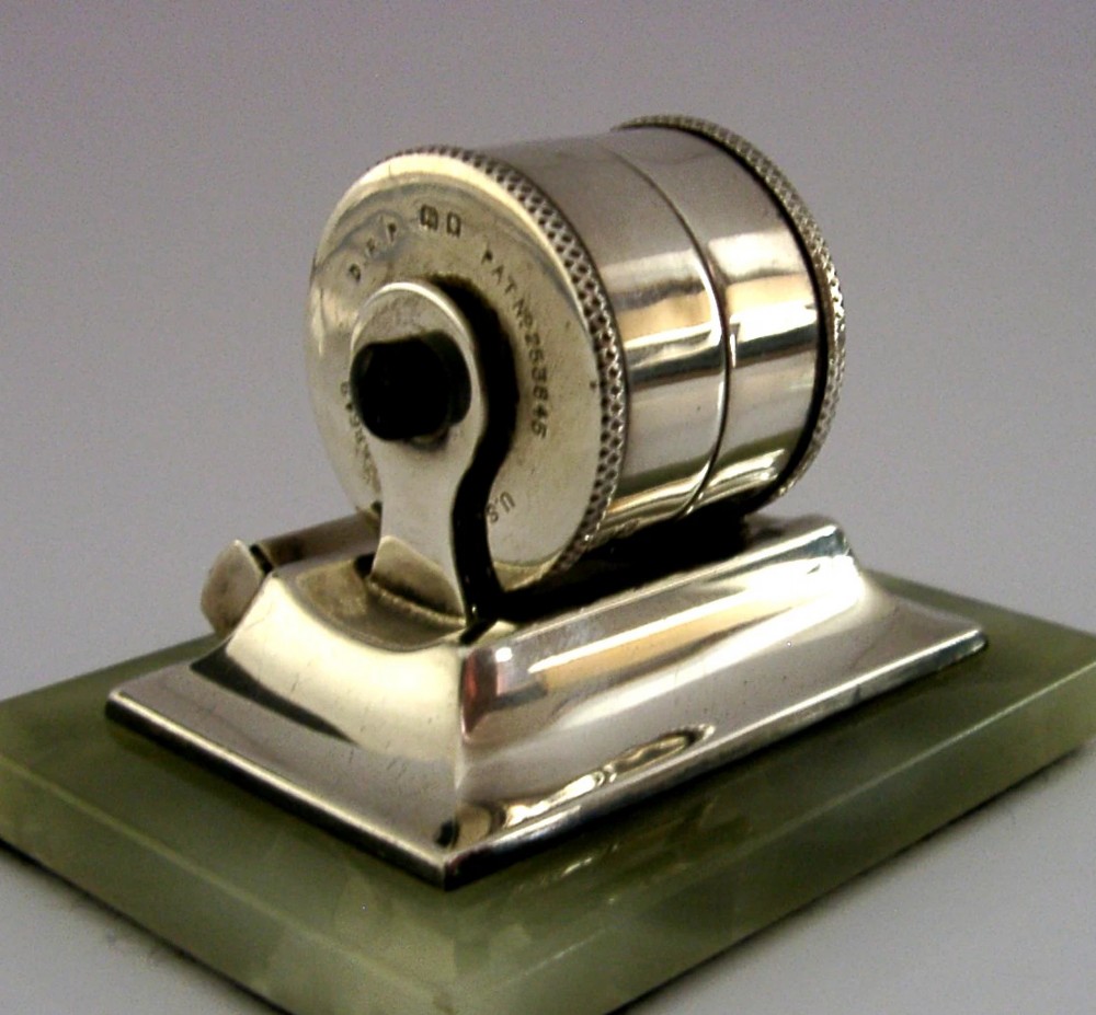 An Art Deco sterling silver mechanical perpetual desk calendar featuring double number rollers mounted on a rectangular pale green onyx base. View III