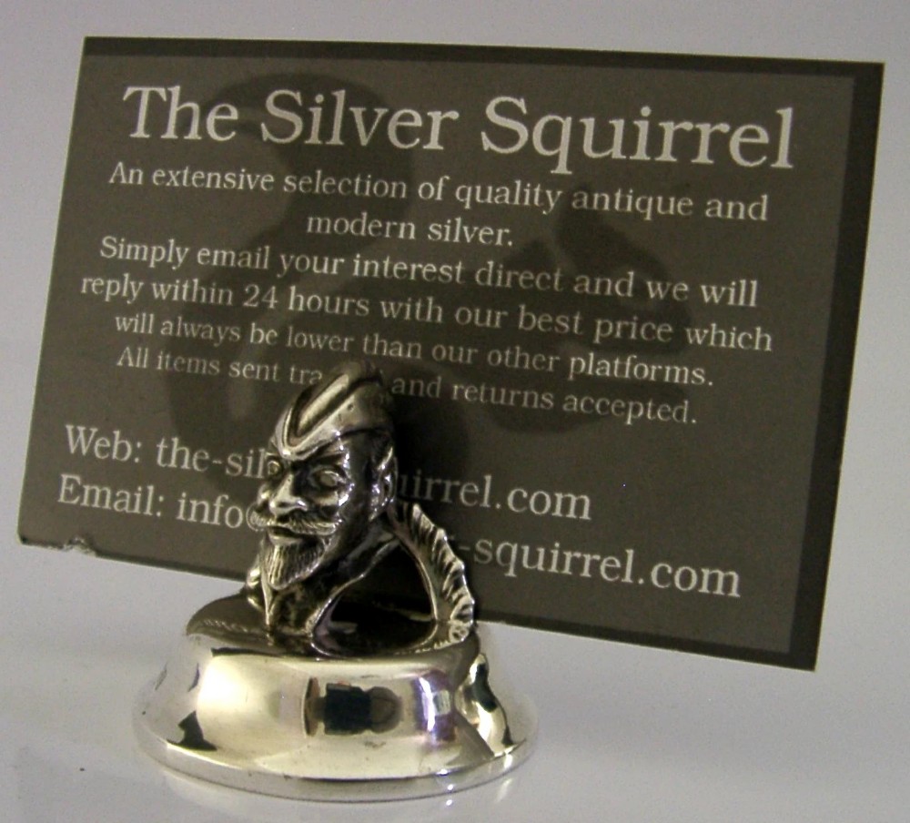 An Edwardian sterling silver menu holder featuring a cast bust of Robin Hood set upon a rounded hallmarked silver base. View VII