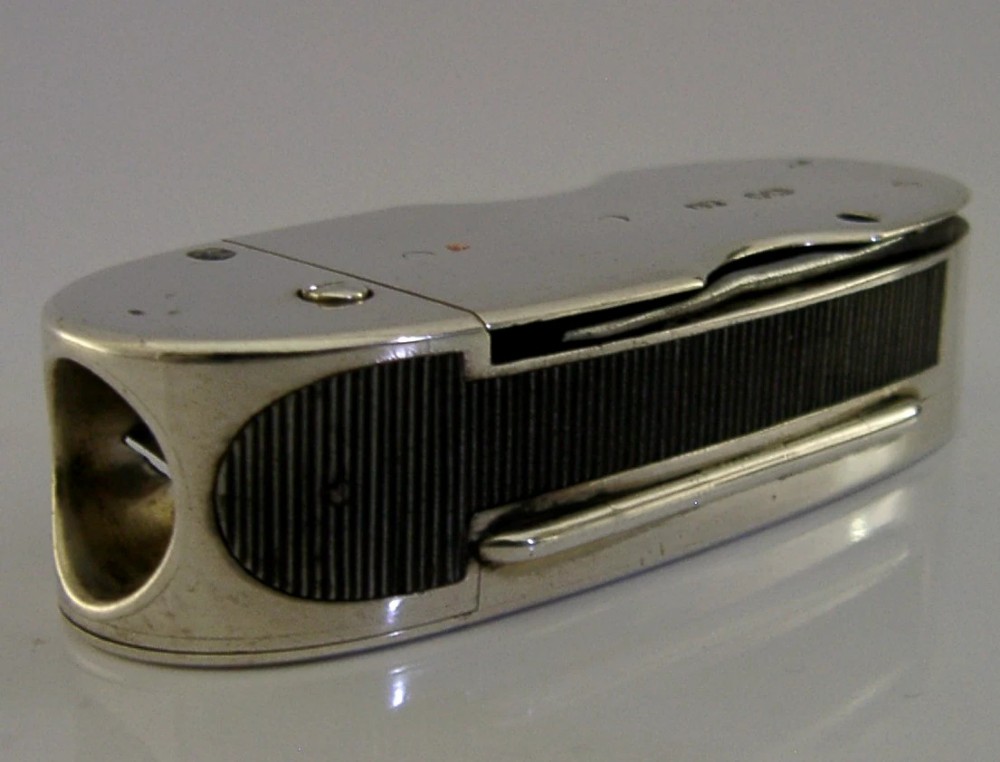 A Victorian sterling silver cigar cutter multi-tool with hallmarked silver casing and open fold-out steel implement. View III