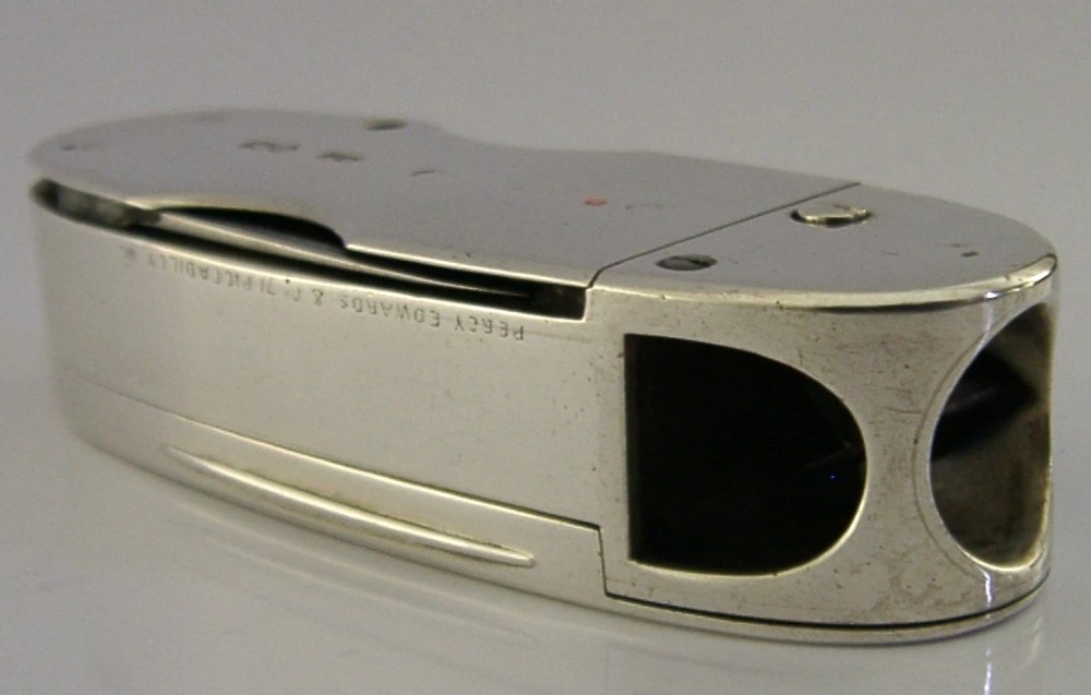 A Victorian sterling silver cigar cutter multi-tool with hallmarked silver casing and open fold-out steel implement. View V