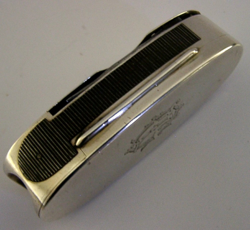 A Victorian sterling silver cigar cutter multi-tool with hallmarked silver casing and open fold-out steel implement. View VII