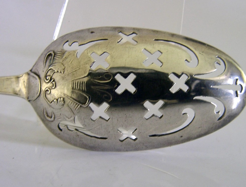 An 18th-century Georgian sterling silver mote spoon with a hand-pierced bowl featuring scroll cutouts and a long stem ending in a pointed tip. View III
