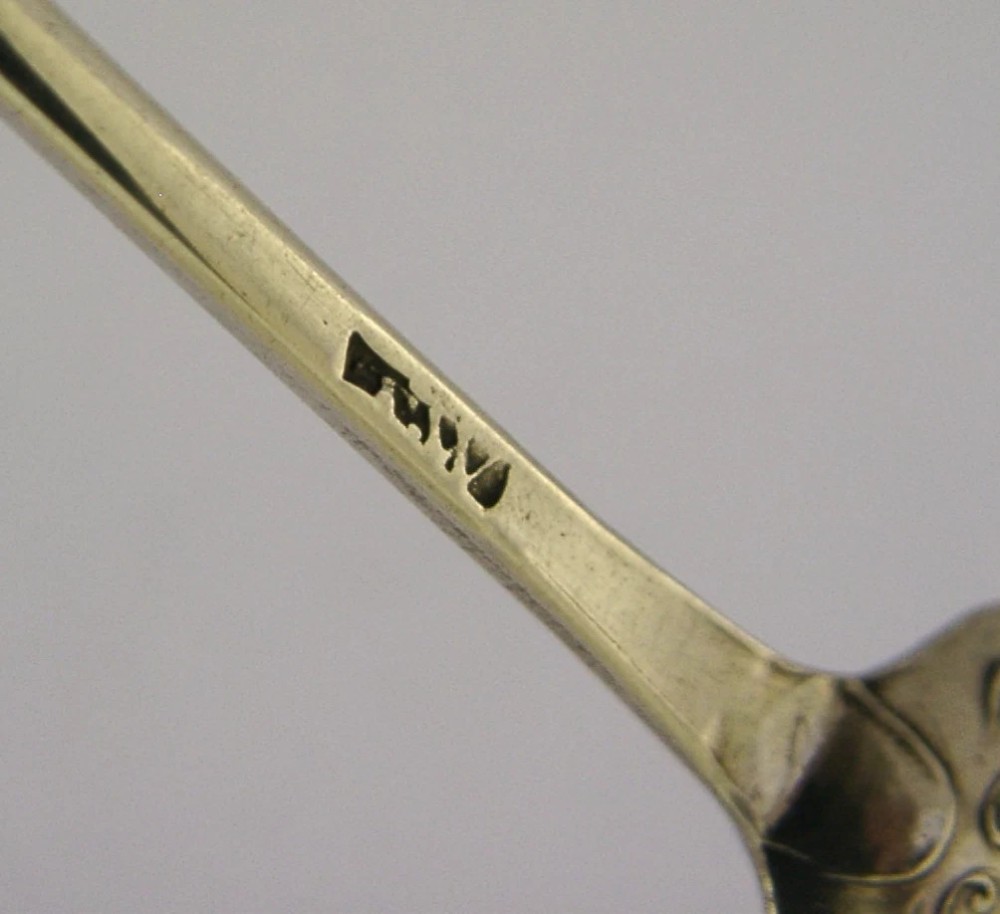 An 18th-century Georgian sterling silver mote spoon with a hand-pierced bowl featuring scroll cutouts and a long stem ending in a pointed tip. View XI